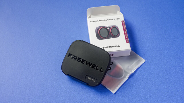 NORWALK, CT, USA - SEPTEMBER 11, 2026:Freewell cpl filter in its case and packaging on a blue background, enhancing camera capabilities
