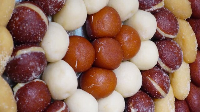 Variety of indian sweet snacks arranged in circular pattern for festival celebration