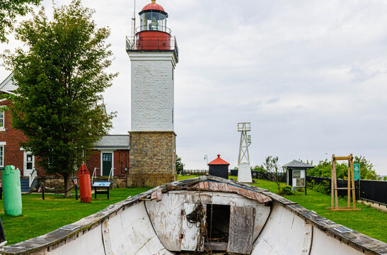 Vintage Life Boat With Brick Tower and Lighthouse at Historic Dunkirk Lighthouse and Veterans Park Museum at Point Gratiot, Dunkirk, New York, USA