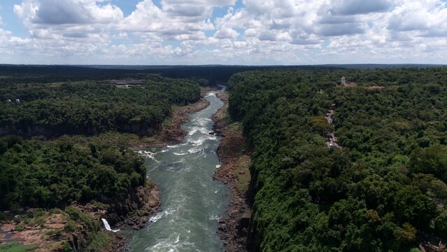Panoramic aerial shot of river rapids and cascading tiers of Iguazu Falls