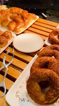Traditional Turkish simit bread rings with sesame seeds on a hotel breakfast buffet counter. Delicious fresh bakery for all-inclusive resort morning catering, travel and vacation food background.