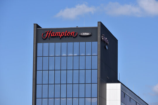 Hampton Hilton hotel facade with emblem, signage, logo. WARSAW, POLAND - APRIL 18, 2026