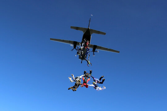 Skydivers jumping from a CASA C-212 aircraft.