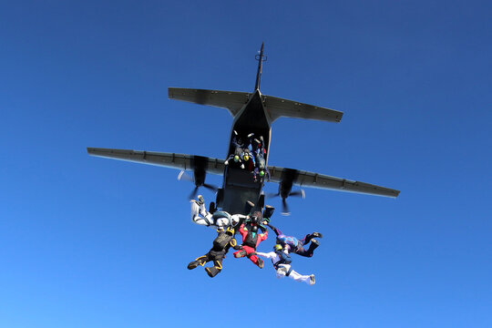 Skydivers jumping from a CASA C-212 aircraft.