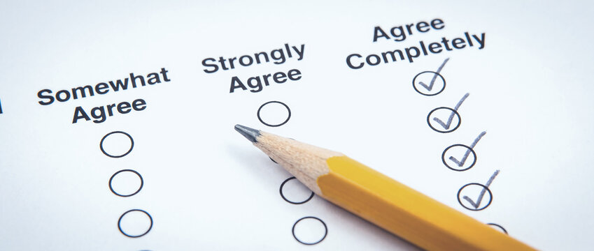 Survey questionnaire paper with checkmarks and opinion checkboxes for market research and customer feedback