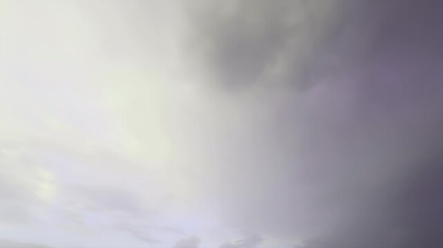 Sky transitions with rapidly moving clouds create a dramatic and dynamic atmosphere. Variations in light and shadow emphasize the depth and texture of the cloud formations.