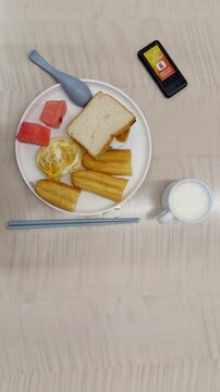 Overhead view of breakfast plate beside restaurant queue calling device