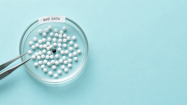 Black ball among white balls in petri dish labeled bad data