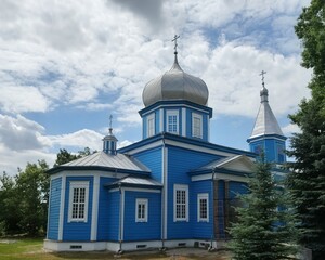 Traditional wooden Orthodox church painted blue with silver domes under a cloudy sky © Ratsam