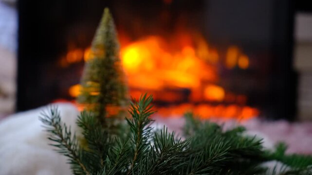 Christmas tree, decorations. Magic of the holiday season. Warm string lights twinkle gently, casting a golden glow. Fireplace,  flame, fir branches adds comforting warmth