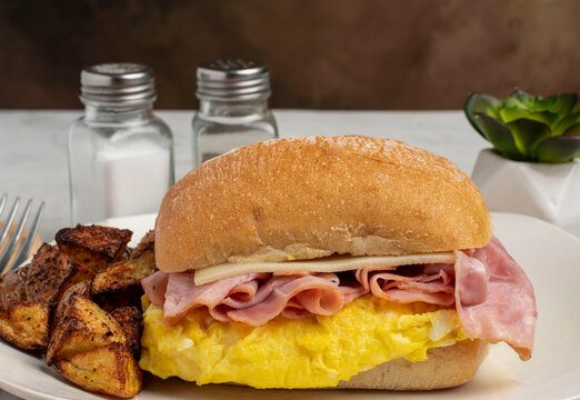 scrable egg breakfast sandwich with  home fries
