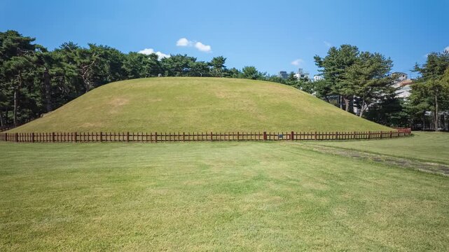  4k Timelapse of Jeongja-gak shrine and royal mound at Jeongneung Royal Tomb under clear blue sky in Seoul