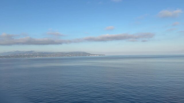 28 April 2026 Italy, Sicily, Strait of Messina - cruise ship sailing in between Punta del Faro and Calabria Pezzo with Mortelle, Sperone and Contrada Forte Spuria