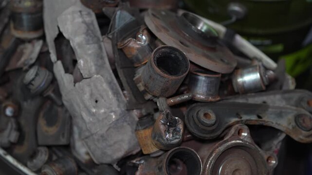 A pile of old rusty worn out car parts collected together.