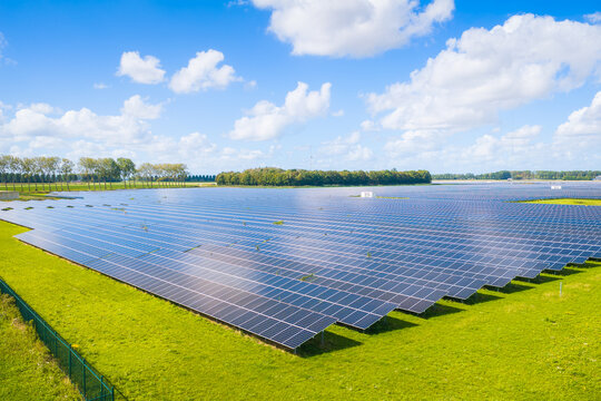 Aerial drone view of solar panels in a renewable energy farm. Sustainable green power station for clean electricity production and environmental technology infrastructure.