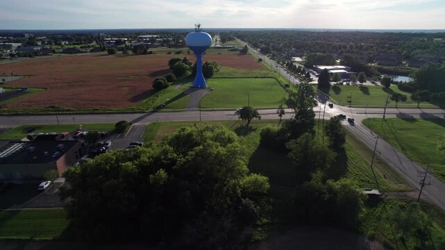Right to Left Aerial of Water Tower in the late afternoon sun.  Blue Skies and summer weather.