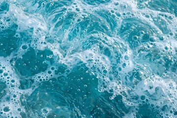 Fototapeta premium ​Splash of Clear Turquoise Blue Water with White Sea Foam and Air Bubbles Macro Texture Background