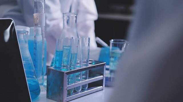 Team Asian scientists in a lab conducting food research using a microscope and lab equipment, showcasing innovation in food science and biotechnology