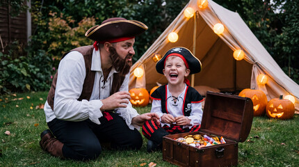 Fototapeta premium White father and son in pirate costumes with treasure chest for adventurous Halloween home party and fall advertising.