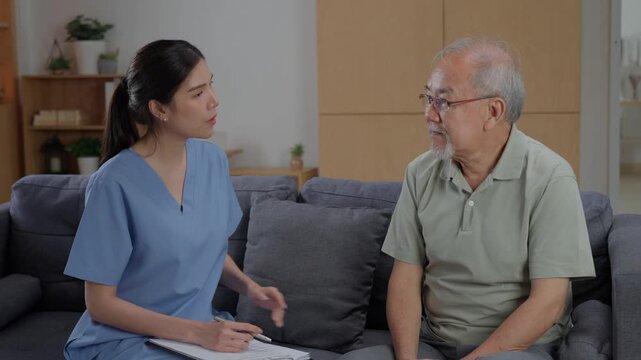 Female nurse documenting health status of elderly couple on clipboard