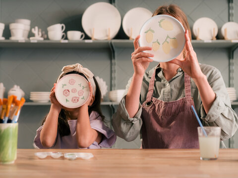 Mother and daughter demonstrating souvenirs they made at studio