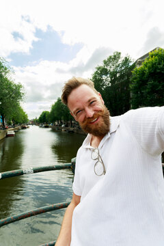 Man Takes Selfie on Bridge Over Canal in Amsterdam
