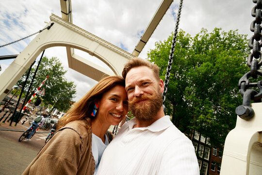 Couple Takes a Selfie by a Bridge in Amsterdam