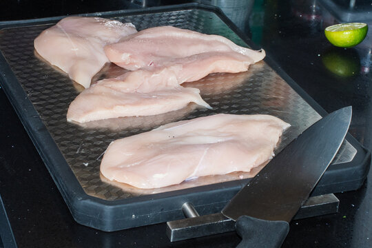 Preparing Raw Chicken Fillets on a Kitchen Counter
