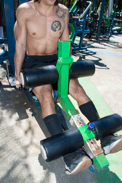 Man Using Workout Machine in a Gym During Daytime