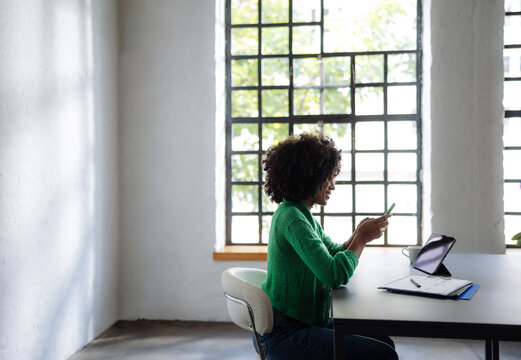 Female Remote Worker Checking Phone