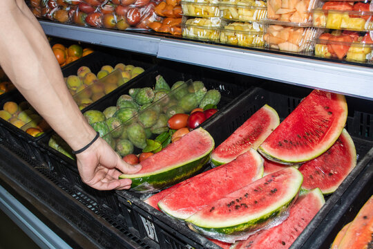 Person Shopping for Watermelon in Grocery Store