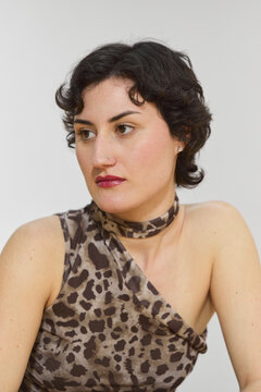 Young Woman with Short Curly Hair in Leopard Print Top