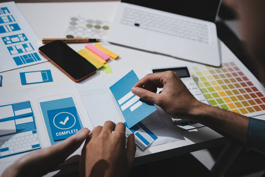 UI designer and UX developer brainstorm idea to design the application appearance in the early stage. Creative digital development agency. UX UI concept