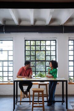 Casual Coworkers Chatting at Modern Office Workspace