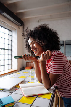 Happy Woman Talking On Phone In Home Office