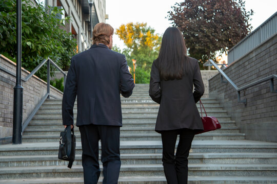 Business colleagues walking up outdoor stairs together