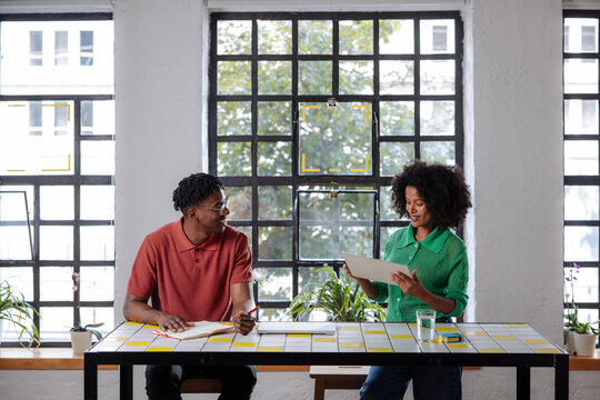 Two Coworkers Collaborating at a Bright Office Table