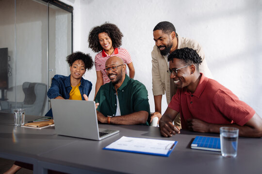 Business Team Smiling During Office Meeting