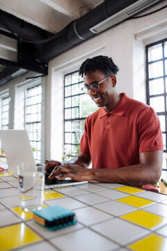 Man Working on Laptop in Modern Office