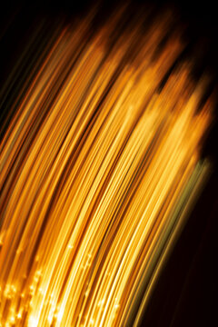 Light Patterns Create a Wave of Gold and Orange Colors in Darkness