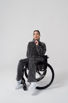 Woman in a Wheelchair Wears Gray Outfit and Poses for a Session