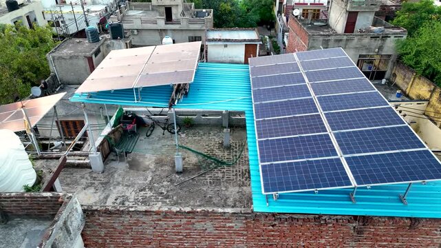 Rooftop photovoltaic solar panels in a sunny Indian town, emphasizing sustainable decentralized electricity.