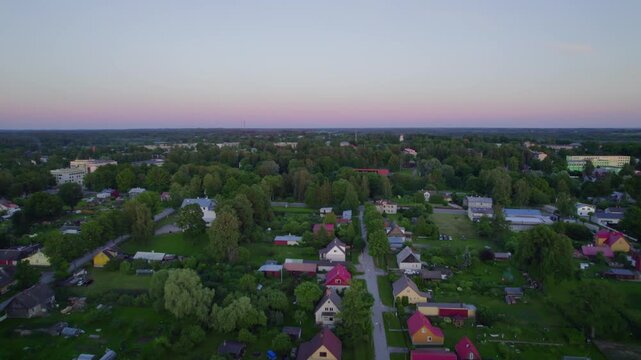 Green Estonian small town at dusk in the summer captured from the drone