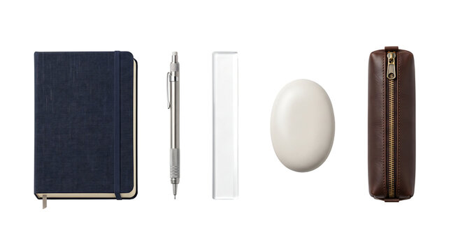 Stationery supplies notebook mechanical pencil glass ruler smooth white stone and leather pencil case for academic work and office organization tasks.