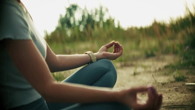 Person Yogic Sitting In Lotus Position Holding Fingers In Gyan Mudra. Outdoor Meditation. Relaxation And Spirituality