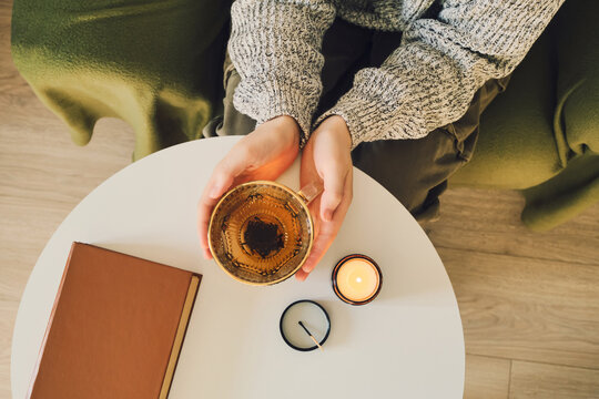 Cozy evening ritual with tea, candle and book