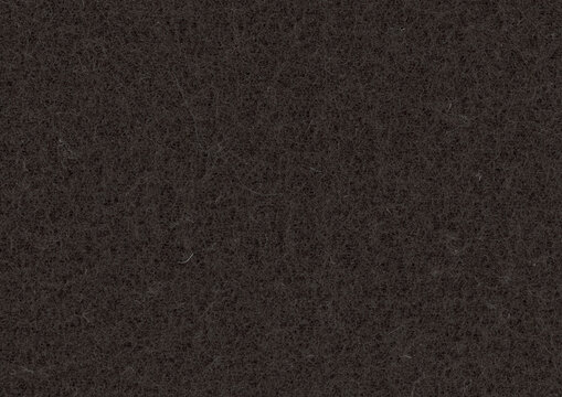 Nonwoven textile background with black fibers gathered around irregular open pores, a coarse felt texture with tangled strands and dark gaps throughout the fabric surface