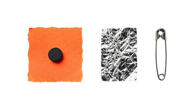 Vibrant orange paper swatch with black button plus crumpled foil sheet and metal pin on transparent background