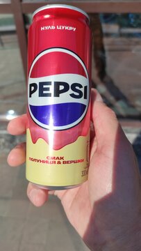 a can of Pepsi-Cola in hand
