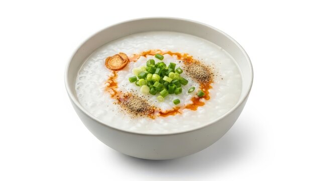 Asian Rice Porridge Congee in Ceramic Bowl with Chili Oil Scallion Garnish Isolated on White